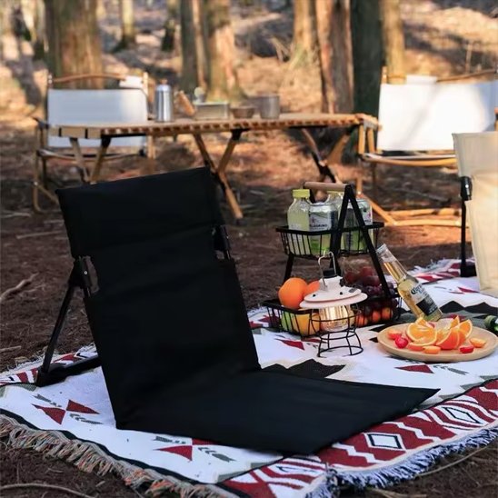 Chaise de camping sur couverture dans la foret pour un pique nique